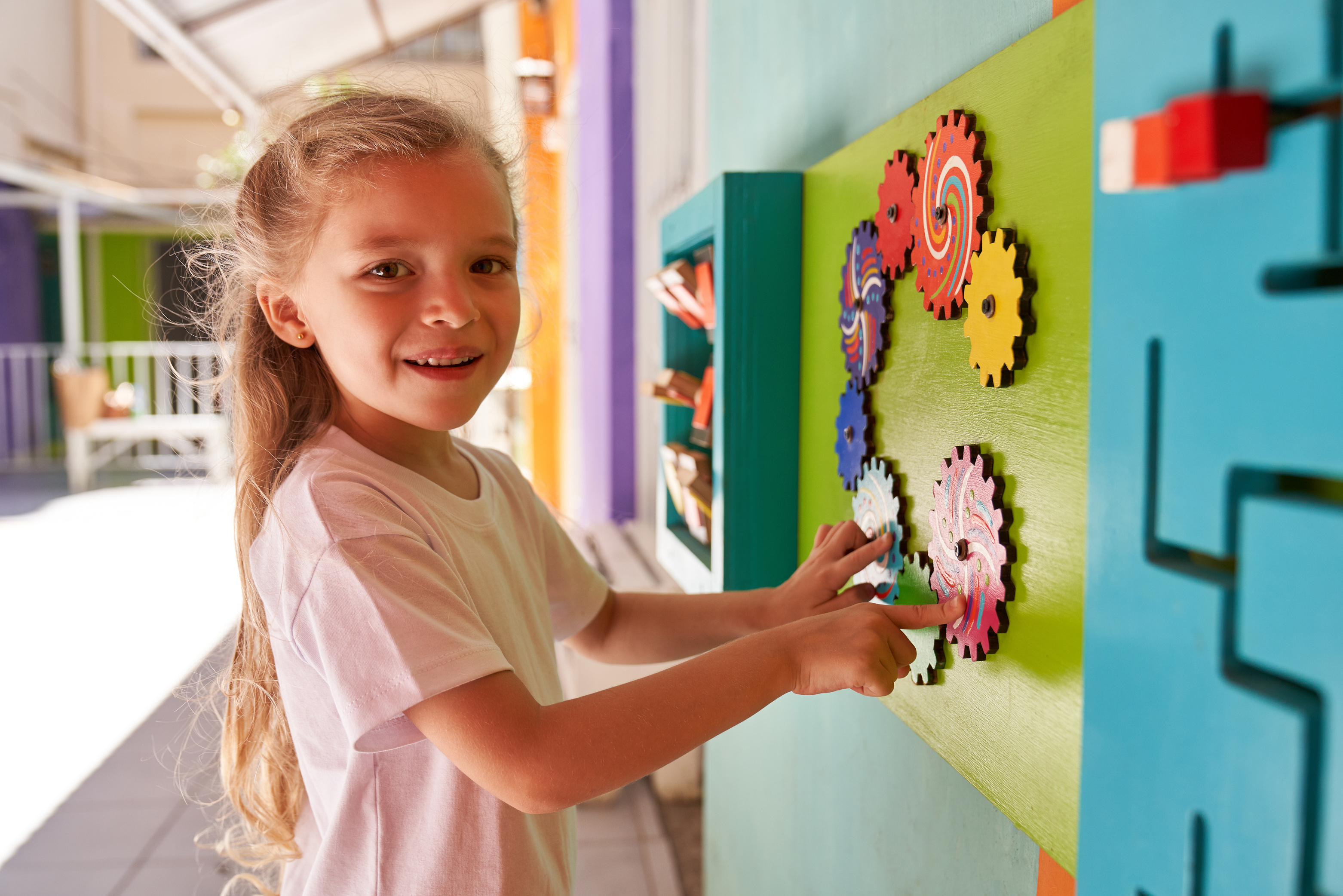 Girl in Kindergarten Plays Creative Wall Game